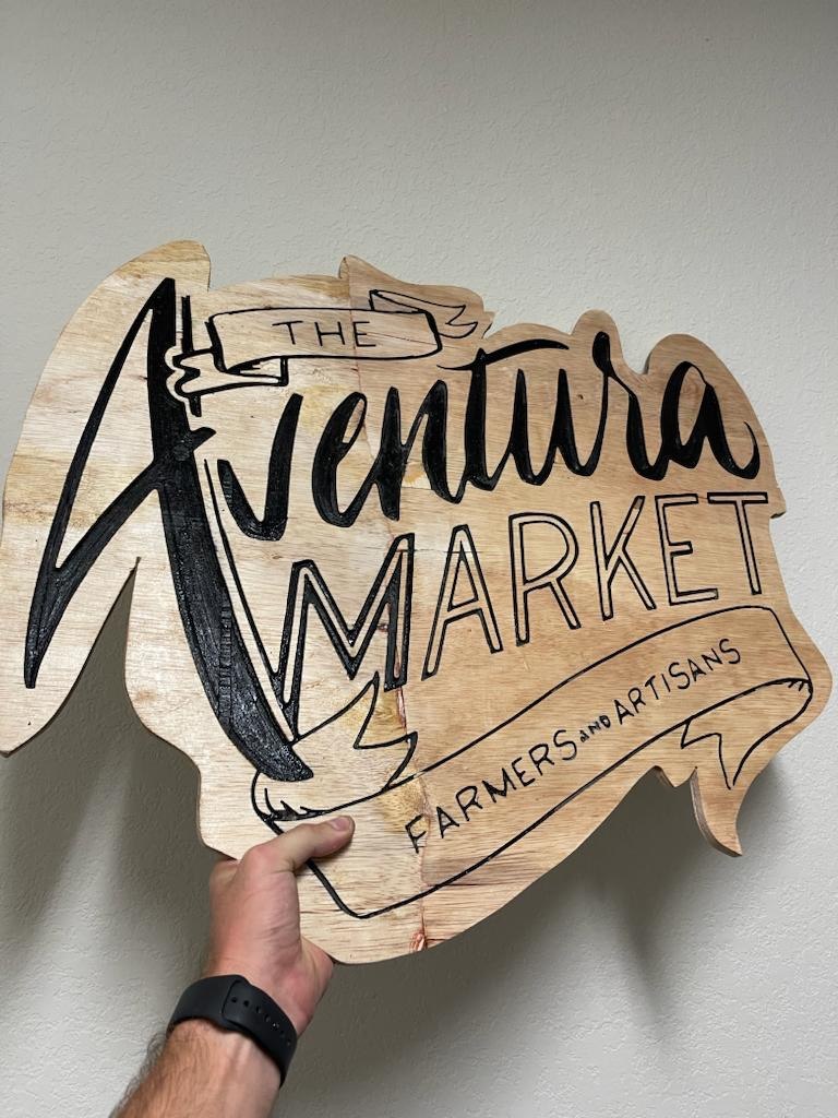 CNC carved wooden business sign for a farmers and artisans market