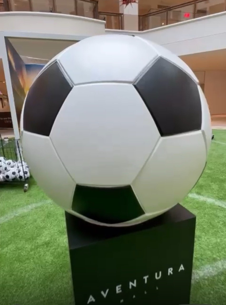 Giant 3D printed soccer ball display at a mall
