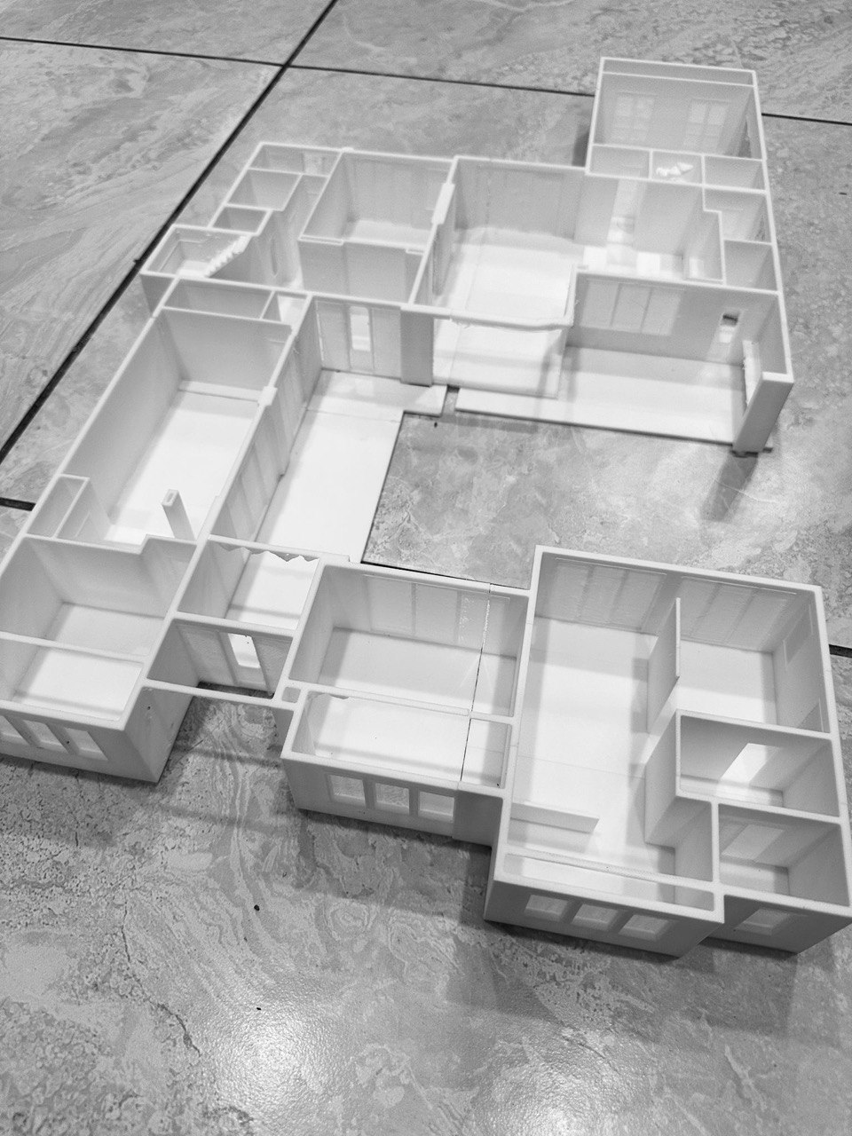Overhead view of a 3D printed architectural house model showing room layout