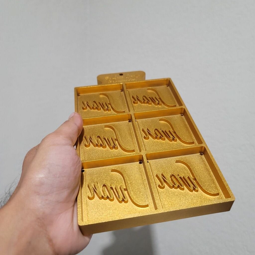 Gold painted six-cavity mold tray with recessed script lettering