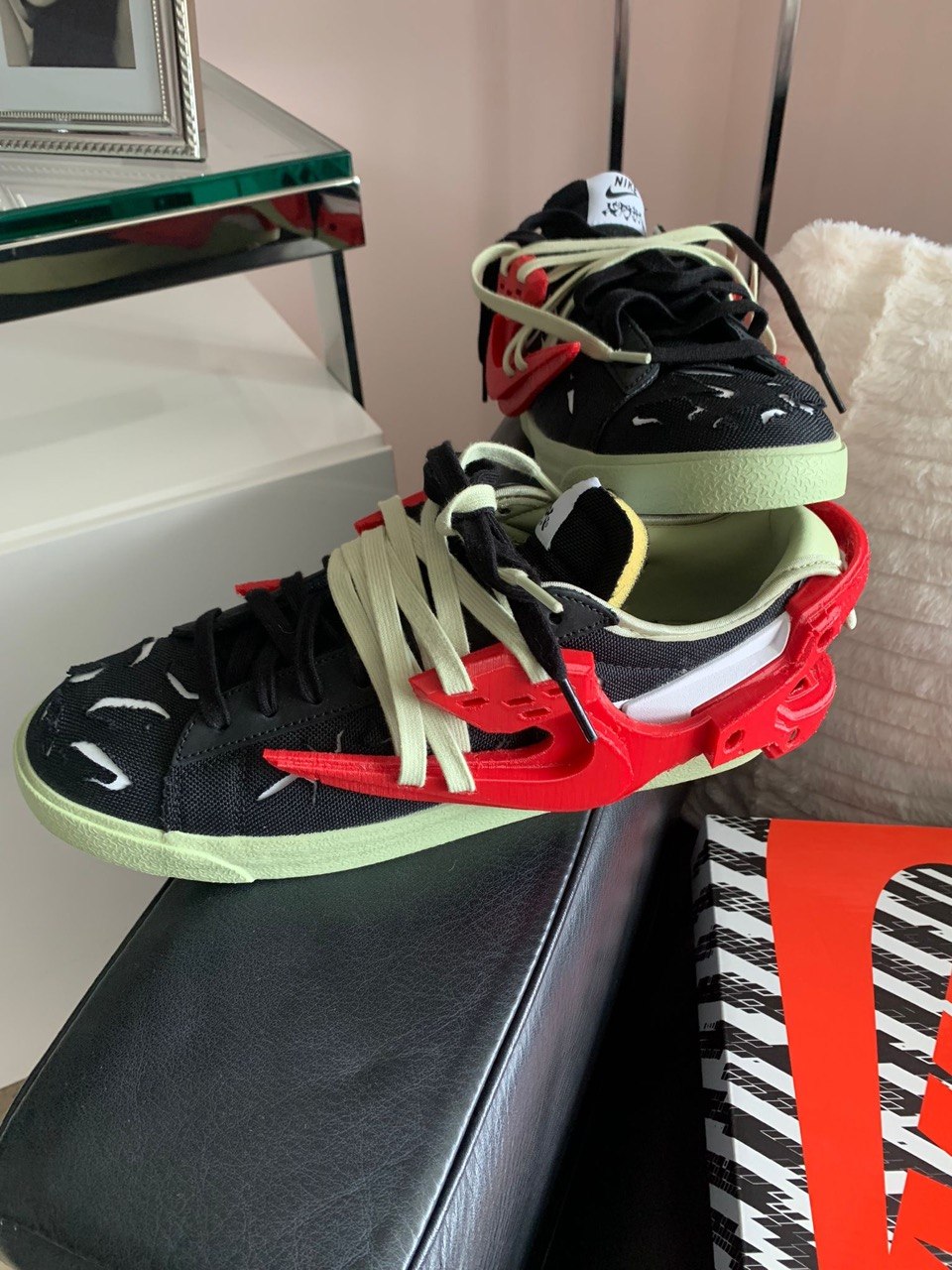 Sneakers fitted with a custom red 3D printed exoskeleton overlay