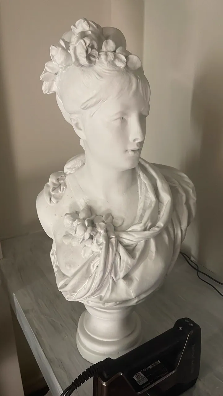 Handheld 3D scanner capturing a classical sculpture bust
