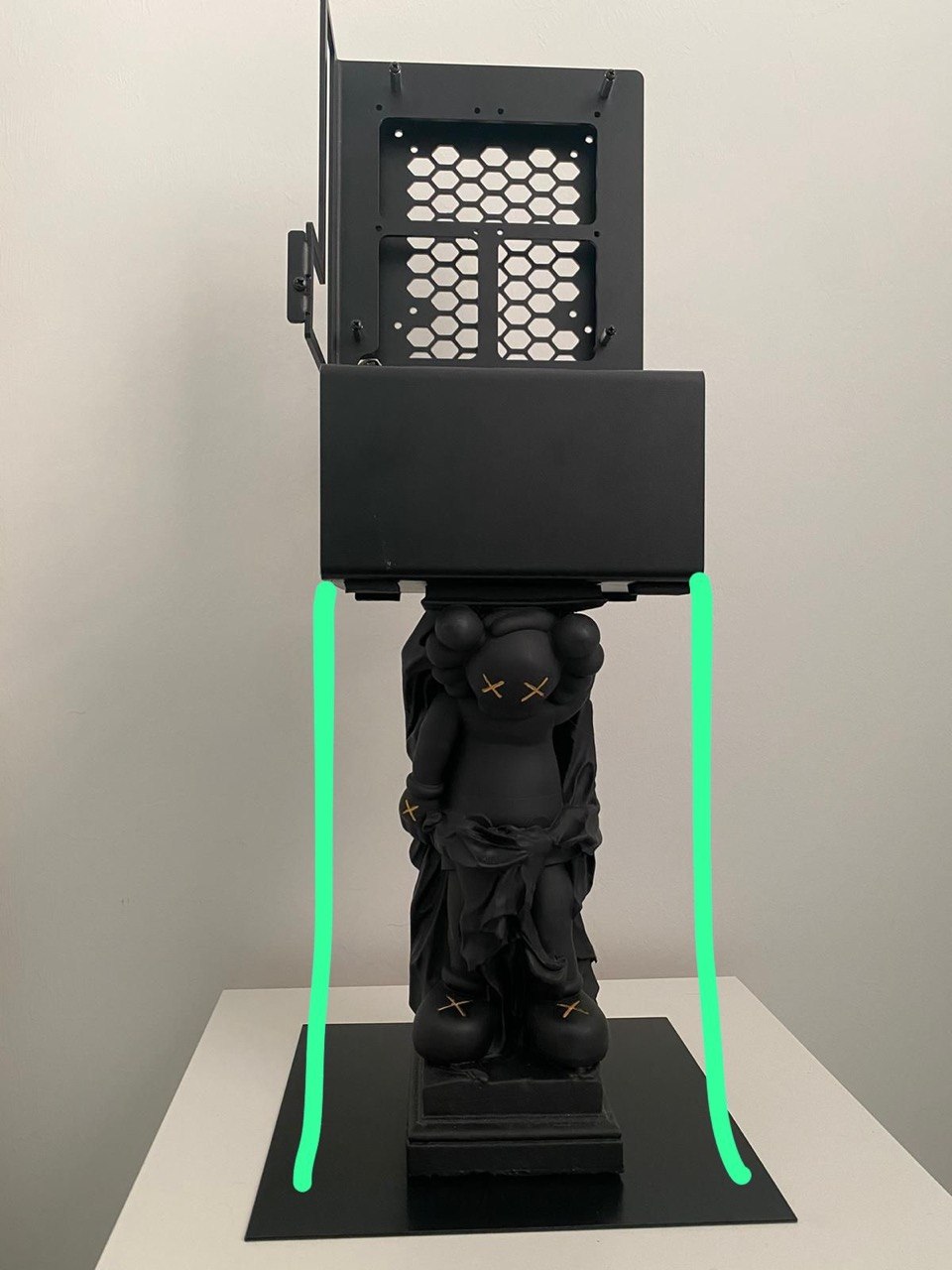Figurine positioned beneath an overhead structured-light 3D scanning rig