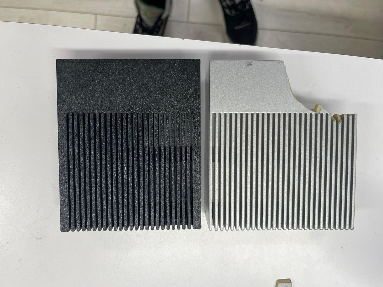 Original aluminum heatsink beside 3D printed replacement shroud