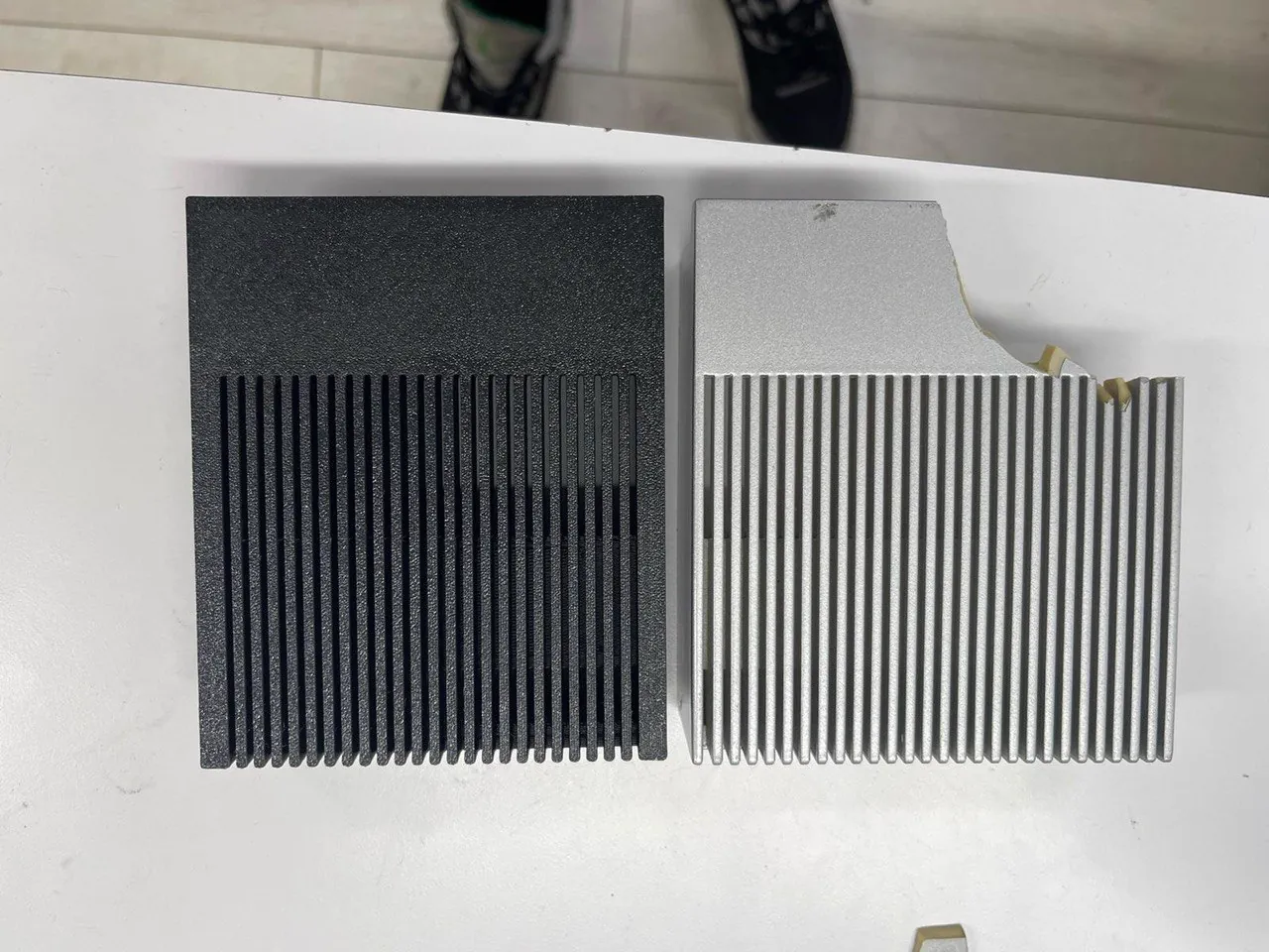 Original aluminum heatsink beside 3D printed replacement shroud