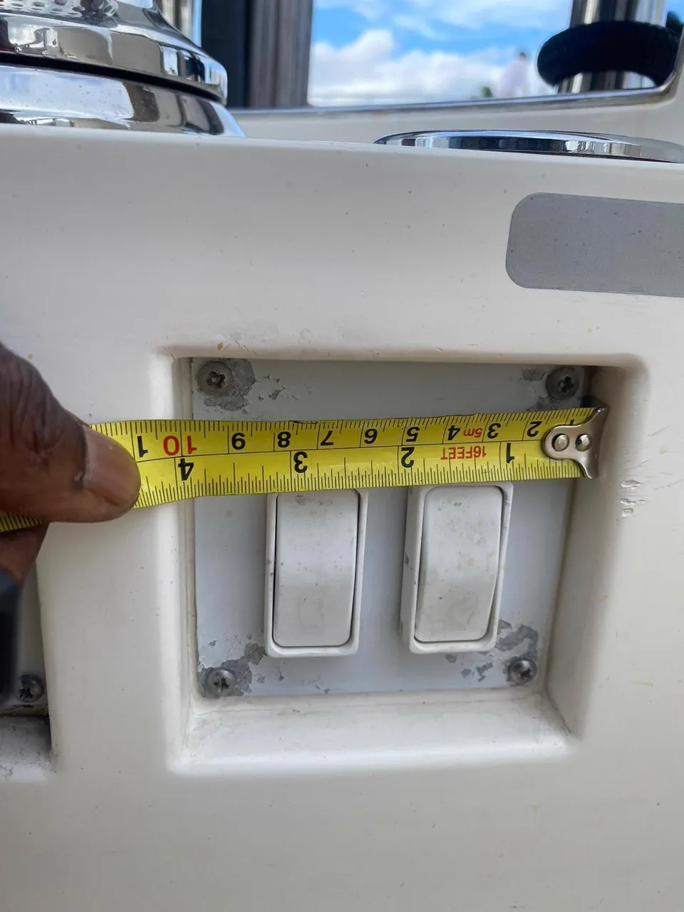 Tape measuring a boat helm rocker switch panel opening